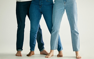 Three women wearing denim jeans